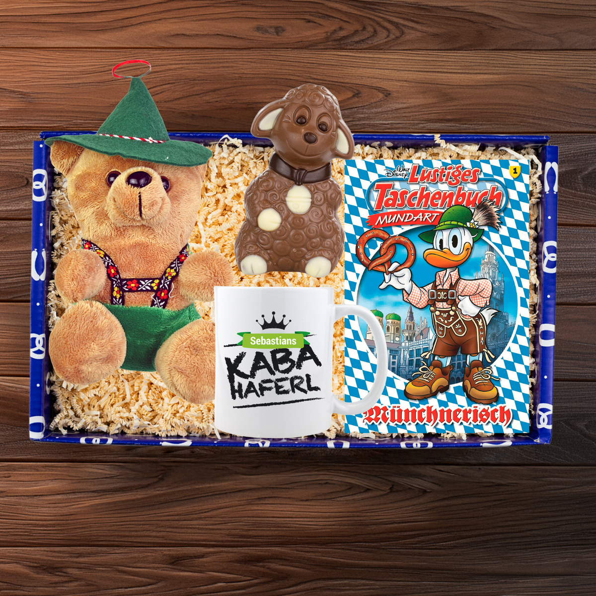 Geschenkbox "Oster-Kuschln" mit Teddybär, Schoko-Lamm, Tasse und lustigem Taschenbuch.