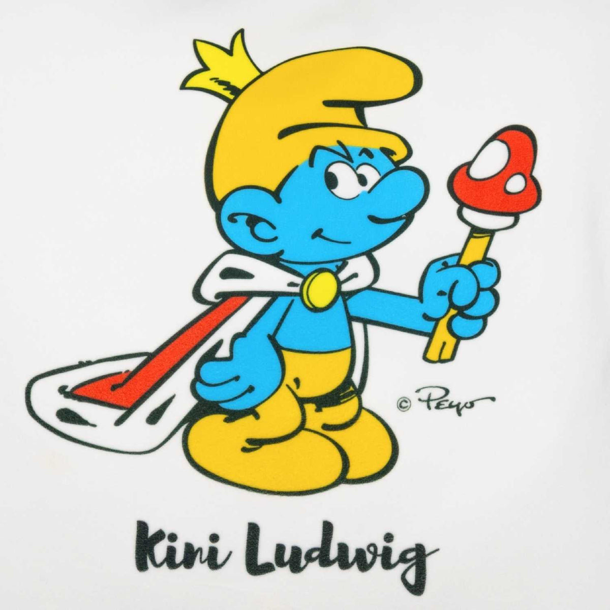 Schlumpf "Kini" Ludwig mit goldener Krone, blauem Umhang und Zepter, auf personalisiertem Kuschelkissen.