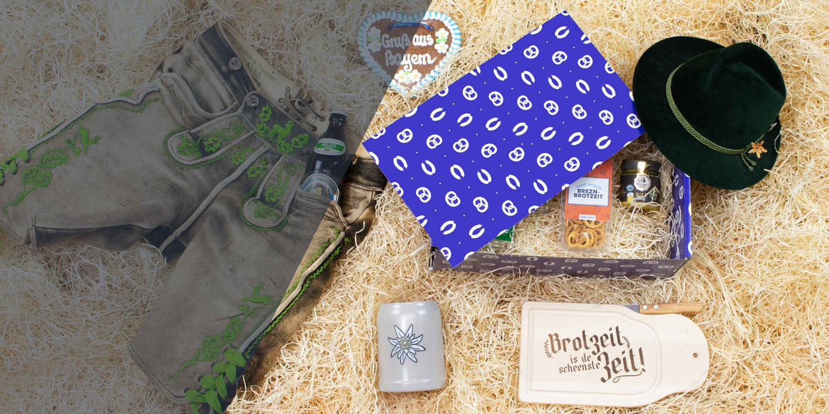 Bayerisches Präsentkorb-Set mit Lederhose, Edelweiß-Krug, Dirndl-Hut, Brotzeit-Brett und Lebkuchenherz.