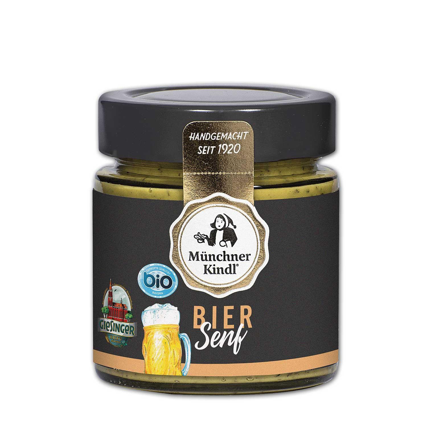Münchner Kindl Bio Bier Senf im Glas mit schwarzem Etikett, goldener Banderole und Giesinger Logo.