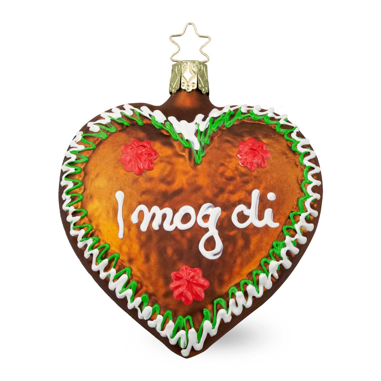 Brauner Christbaumschmuck Lebkuchenherz I mog di mit weißer und grüner Zuckerguss-Verzierung und roten Blüten, glänzend.