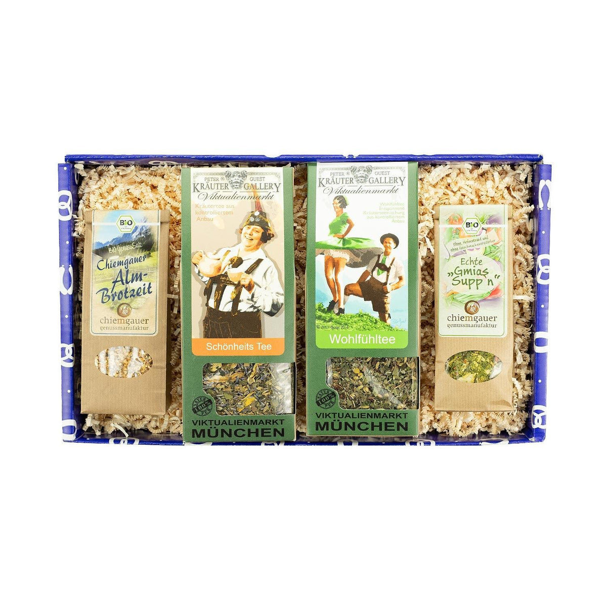 Geschenkbox Boarische Wellness mit verschiedenen Teesorten, Kräutersalz und Gemüsesuppe in blauer Schachtel.