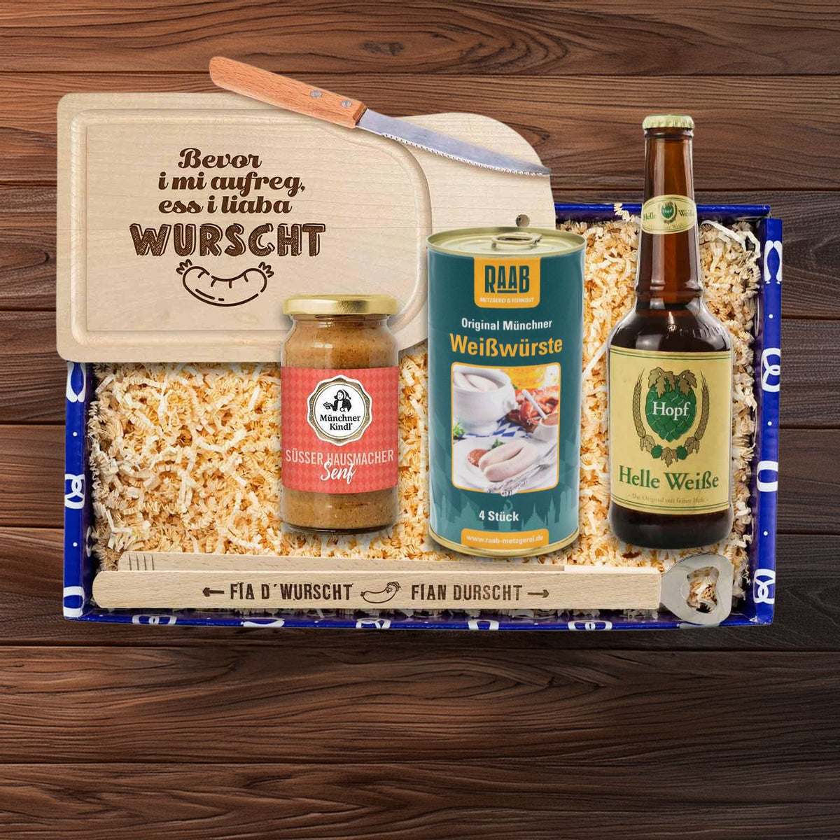 Bayerische Geschenkbox mit Weißwürsten, süßem Senf, heller Weißbierflasche, Schneidebrett und Öffner.