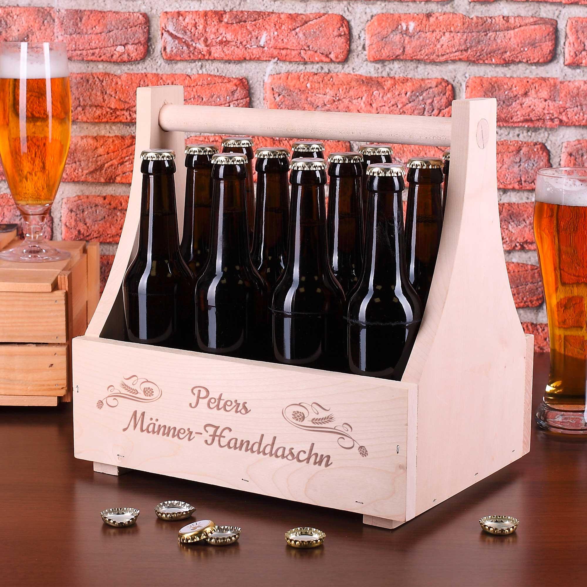 Personalisierte hölzerne Bierbox mit braunen Flaschen, Biergläsern und Kronkorken auf rustikalem Tisch.