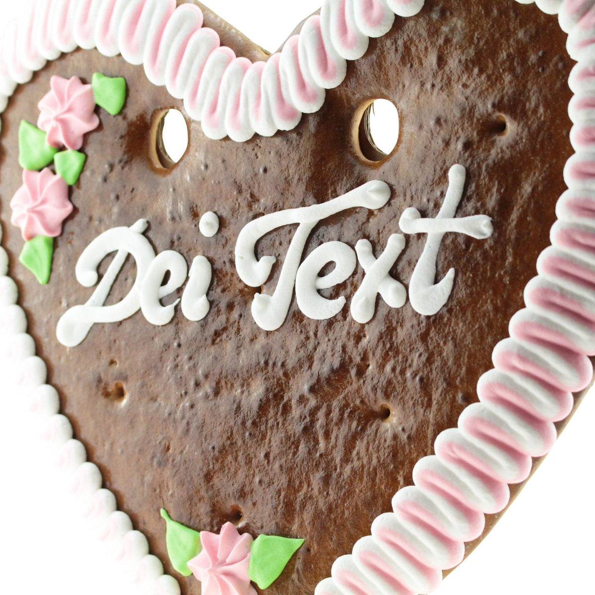 Braunes Lebkuchenherz mit rosa-weißer Zuckerrandverzierung, rosa Zuckerblumen und Schriftzug "Dei Text".