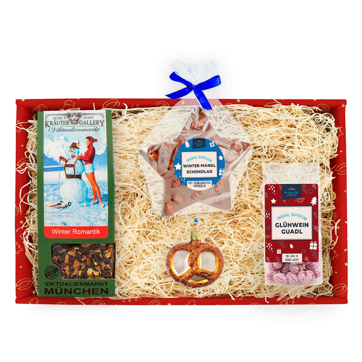 Die Weihnachtsbox "Bescherung" enthält Tee, Mandelschokolade, Glühwein-Bonbons und einen Brezel-Anhänger auf Holzwolle.