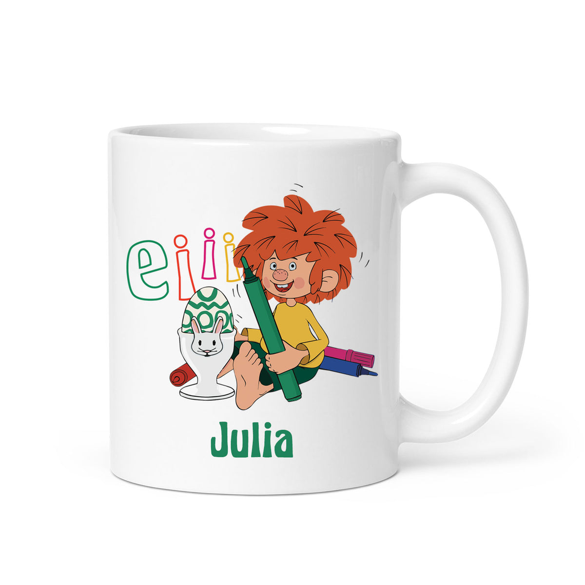 Weiße Tasse mit Pumuckl und blau, grün, rot geschriebenen "Eii", einem Osterei mit Hasenbecher und dem Namen Julia.