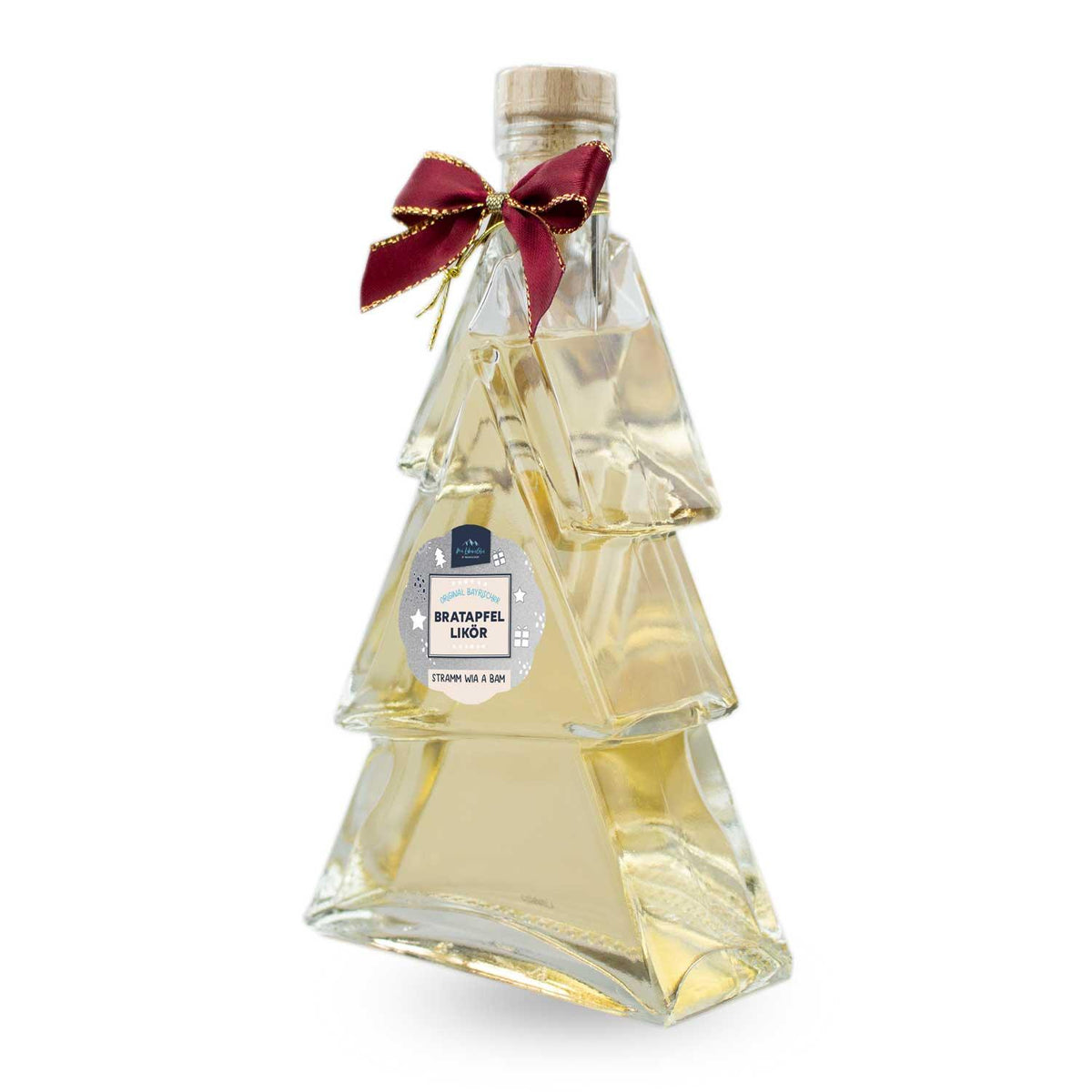 Festlicher Bratapfel-Likör Tanne in Glasflasche mit Tannenumriss, roter Schleife und Korkverschluss.