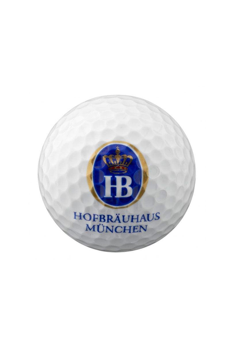 Weißer Golfball mit dem blauen Hofbräuhaus München Logo und Kronen-Emblem