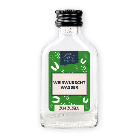 Klarer Obstbrand in Mini-Glasflasche mit weiß-blauem Etikett und Schriftzug „Weißwurschtwasser“, 2cl Inhalt.