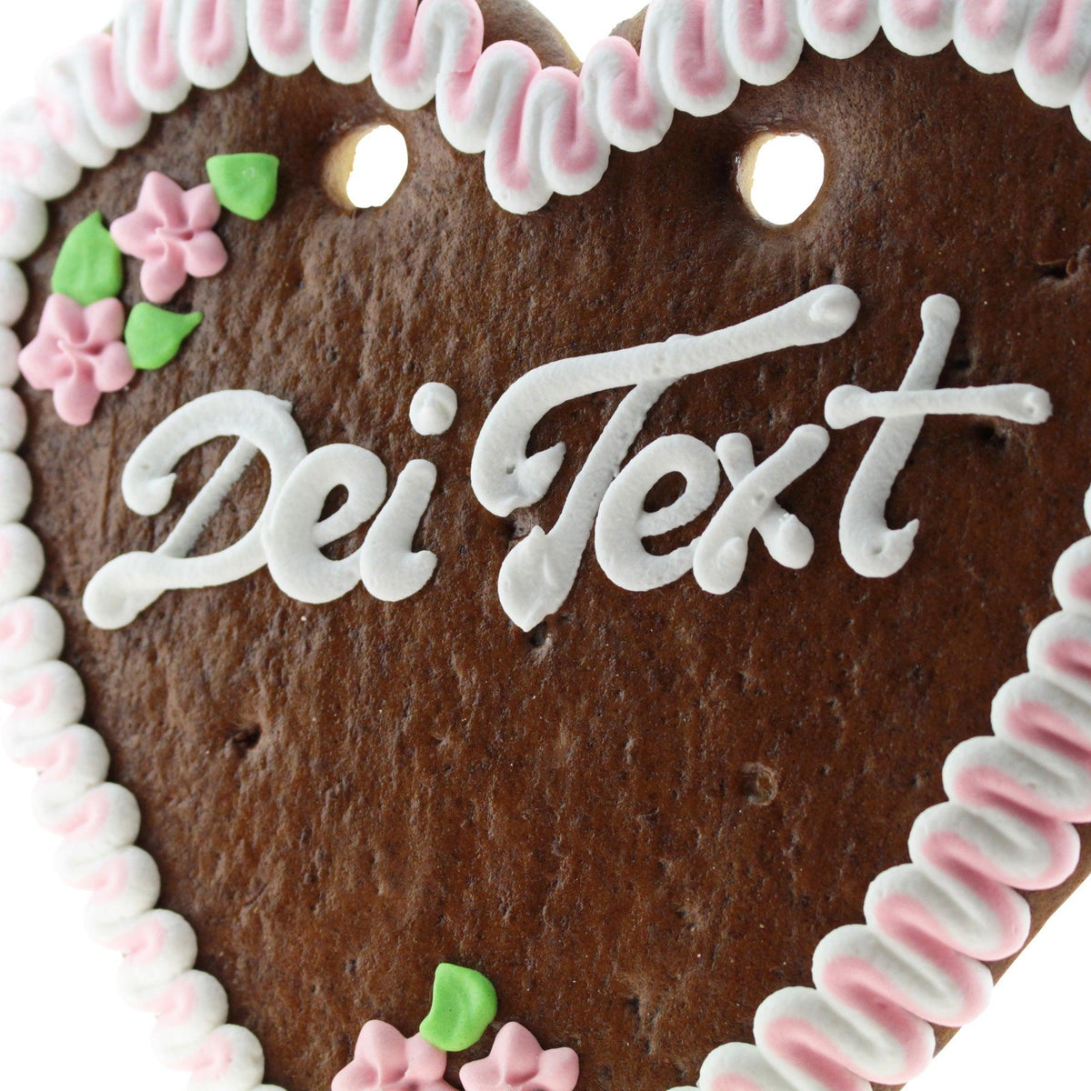 Braun-braunes Lebkuchenherz mit weißer Zuckergussumrandung und pinken Blumenverzierung, Schriftzug „Dei Text“.
